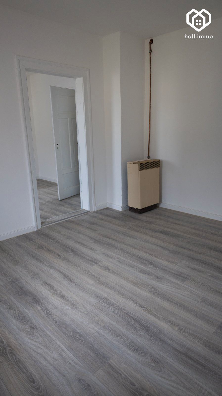 Zimmer mit Heizkörper und Durchgang